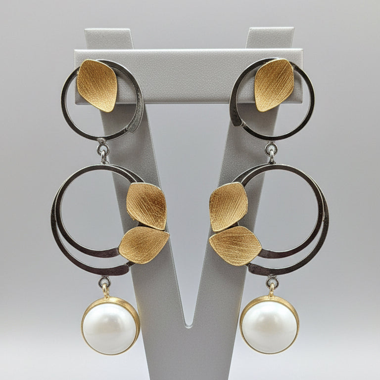Pair of earrings with circular designs and leaf-like elements