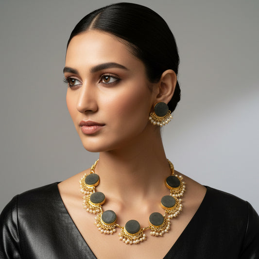 Jewelry set with necklace and earrings on a dark fabric background