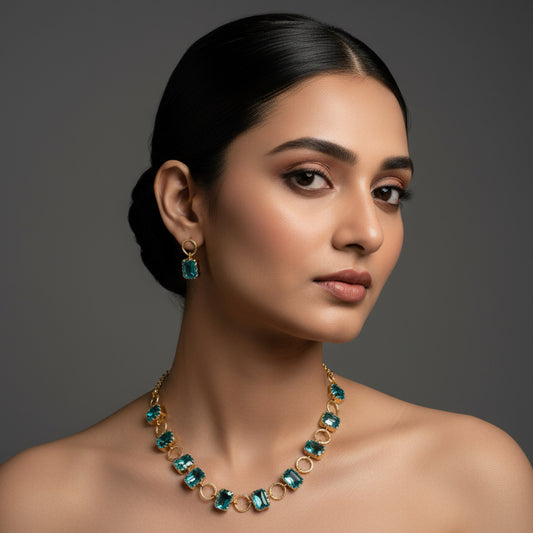 Gold necklace with blue gemstones on a dark surface