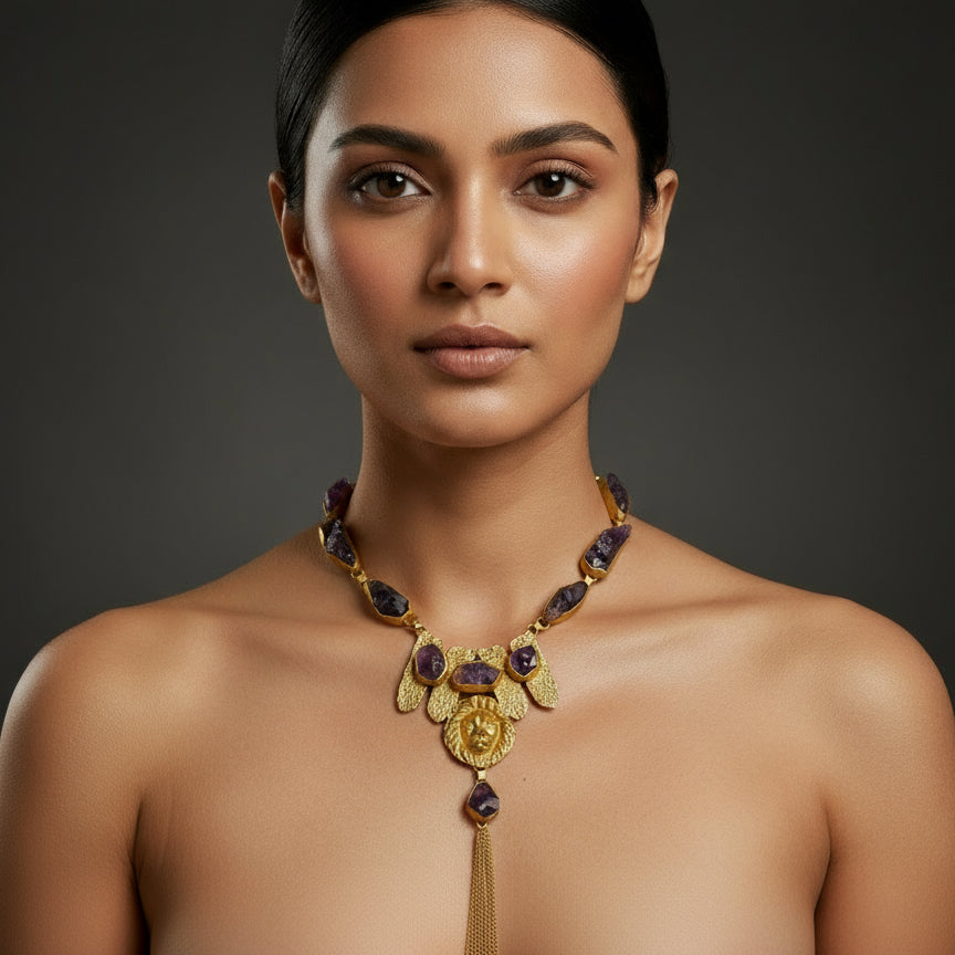 brass necklace with purple stones on a textured black background