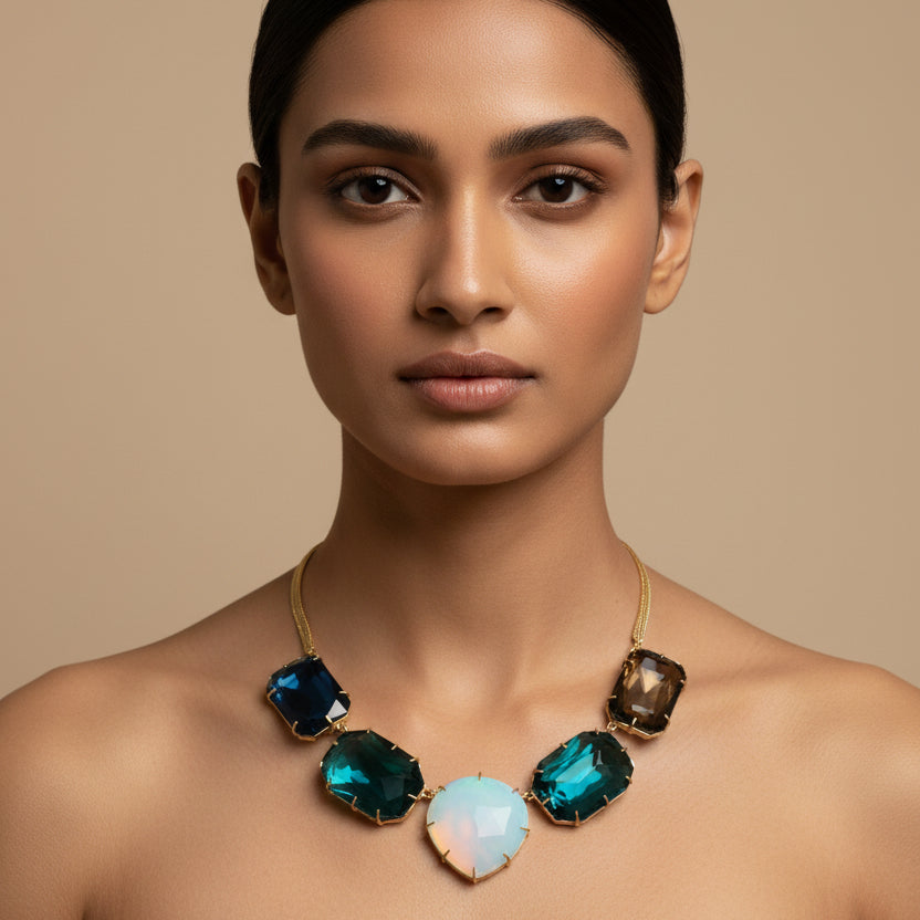 Necklace with blue and green stones on a light gray background