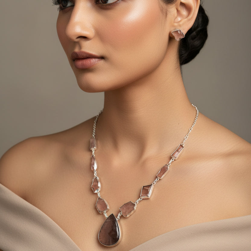 Necklace and earrings with stone-like beads on a dark surface