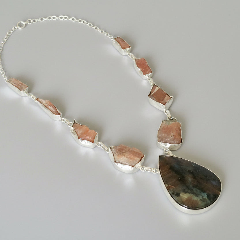 Necklace with large teardrop-shaped stones on a dark fabric background
