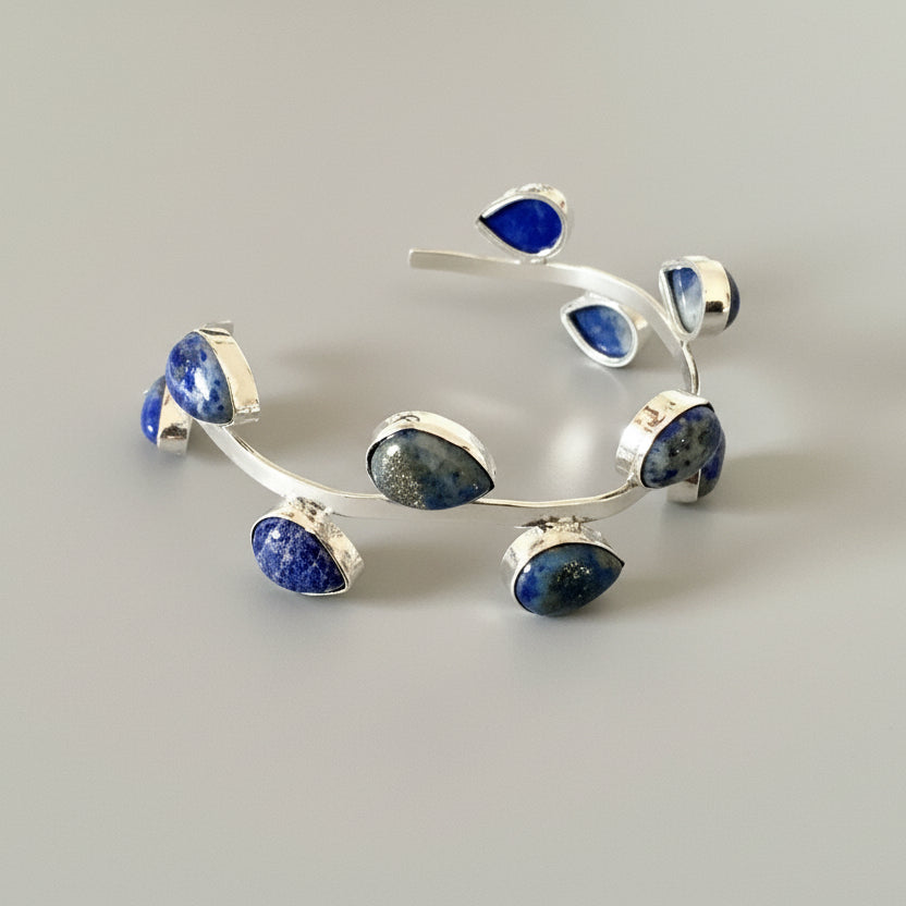 Silver bracelet with blue stones on a dark background