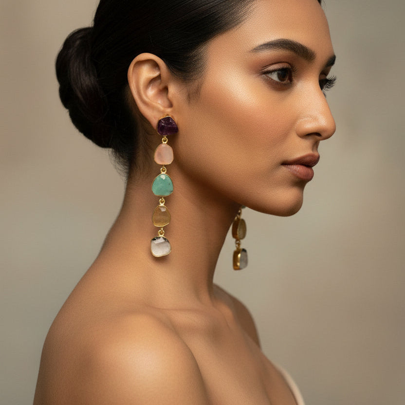 Multicolored beaded earrings on a dark fabric background