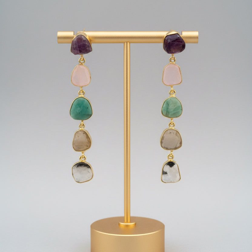 Multicolored beaded earrings on a dark fabric background