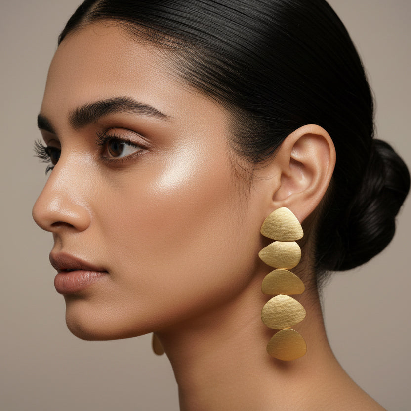 Pair of gold earrings on a dark background