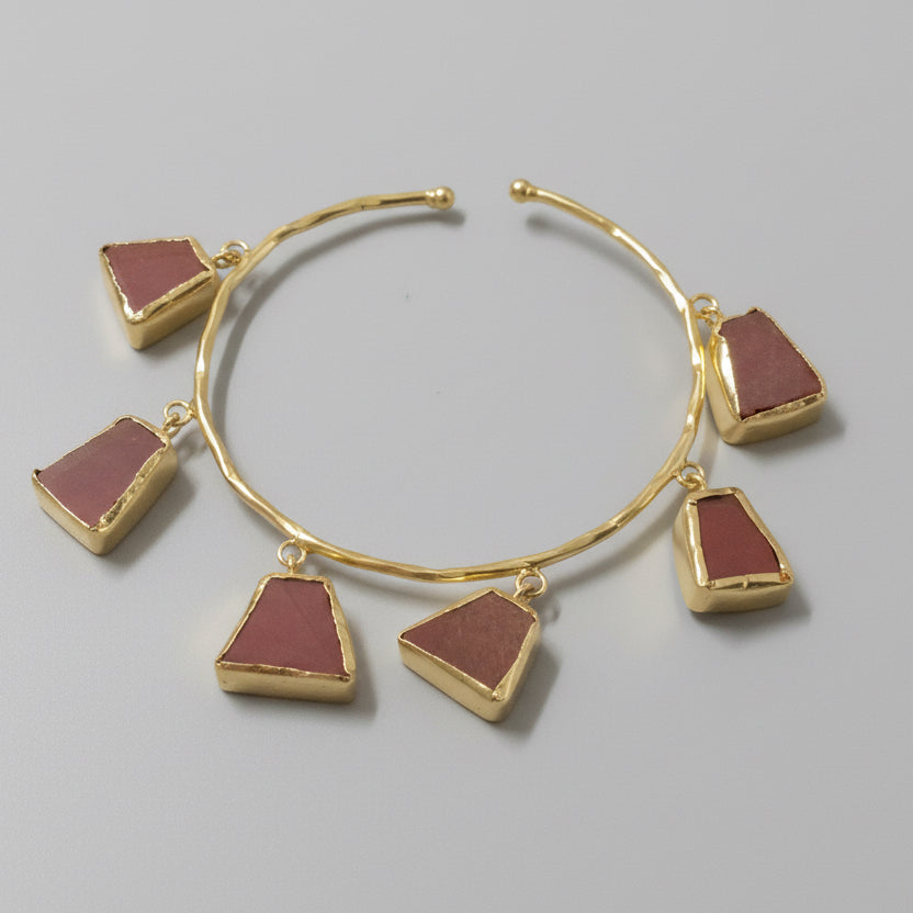 Bracelet with triangle-shaped brown charms on a black background