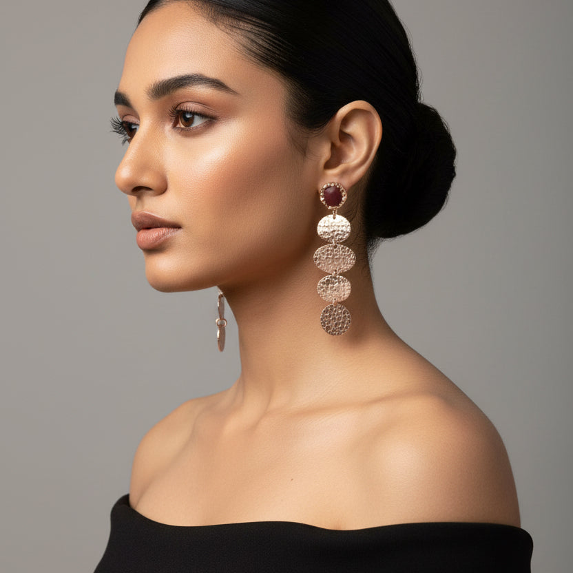 Pair of dangling earrings on a black background