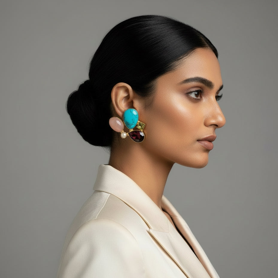 Pair of earrings with colorful gemstones on a dark background