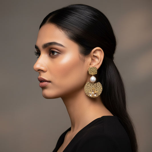 Gold earrings with pearl and leaf-like stone design 