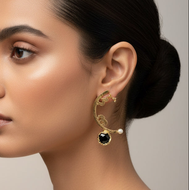 Gold earrings with black and pearl accents with black uncut black stone 