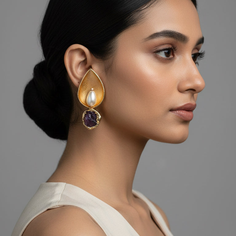 Two teardrop-shaped jewelry pieces with gemstones 