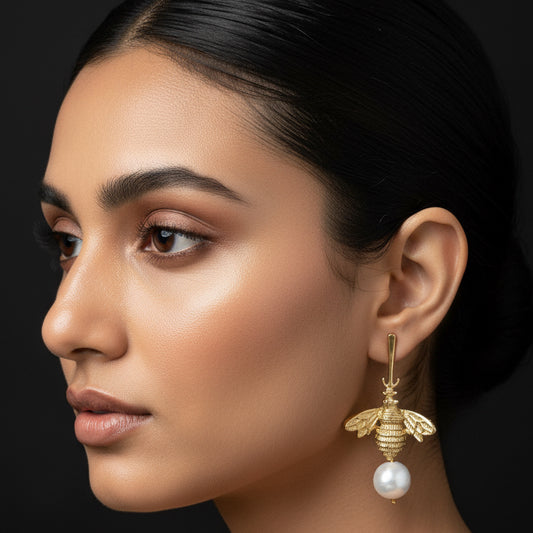 Gold bee-shaped earrings with pearl-like beads 