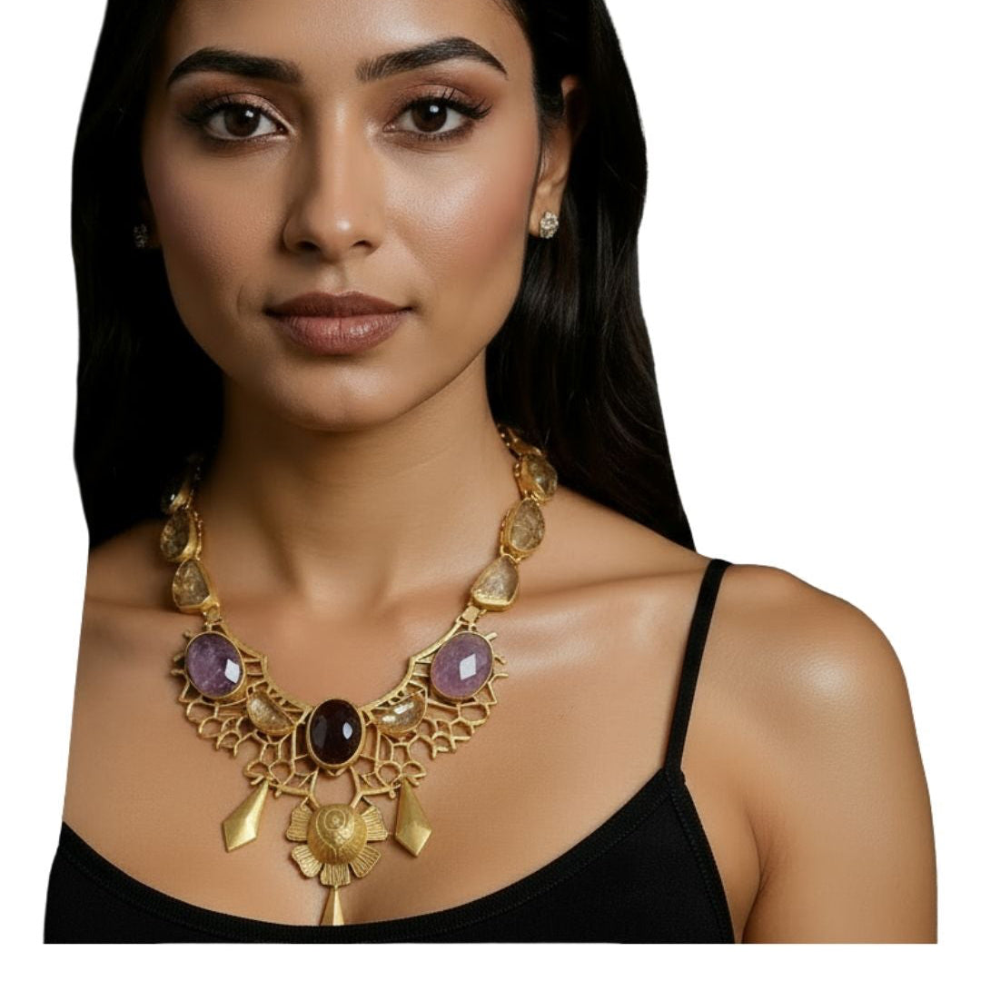 Woman wearing a brass necklace with purple stones on a white background