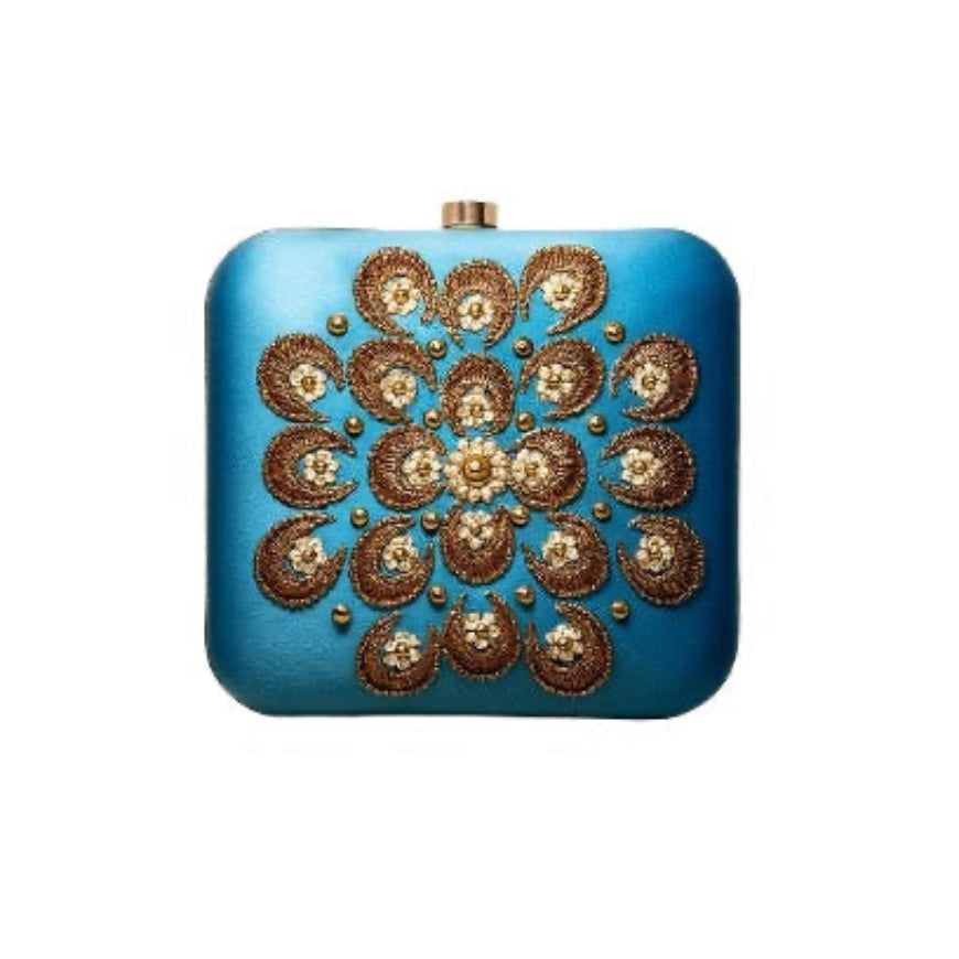 Blue clutch bag with gold floral embroidery on a white background