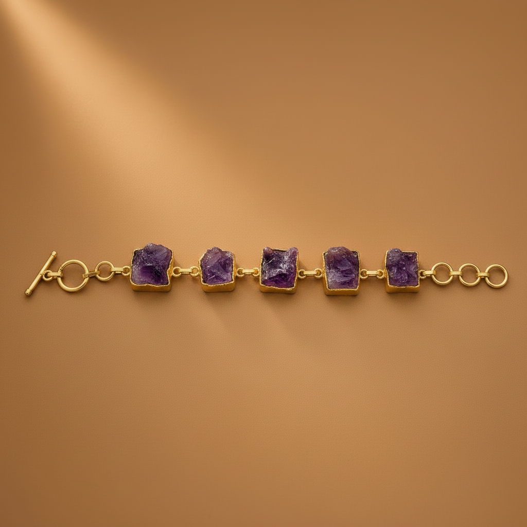Gold bracelet with triangular brown stones on a brown background