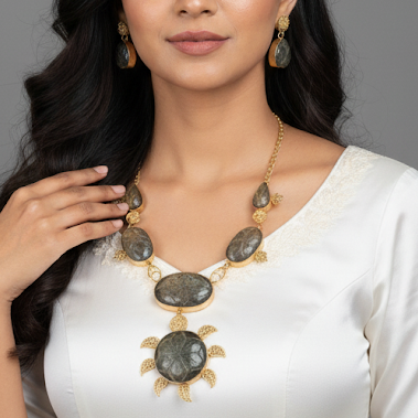 Woman wearing a white dress with a necklace on a gray background