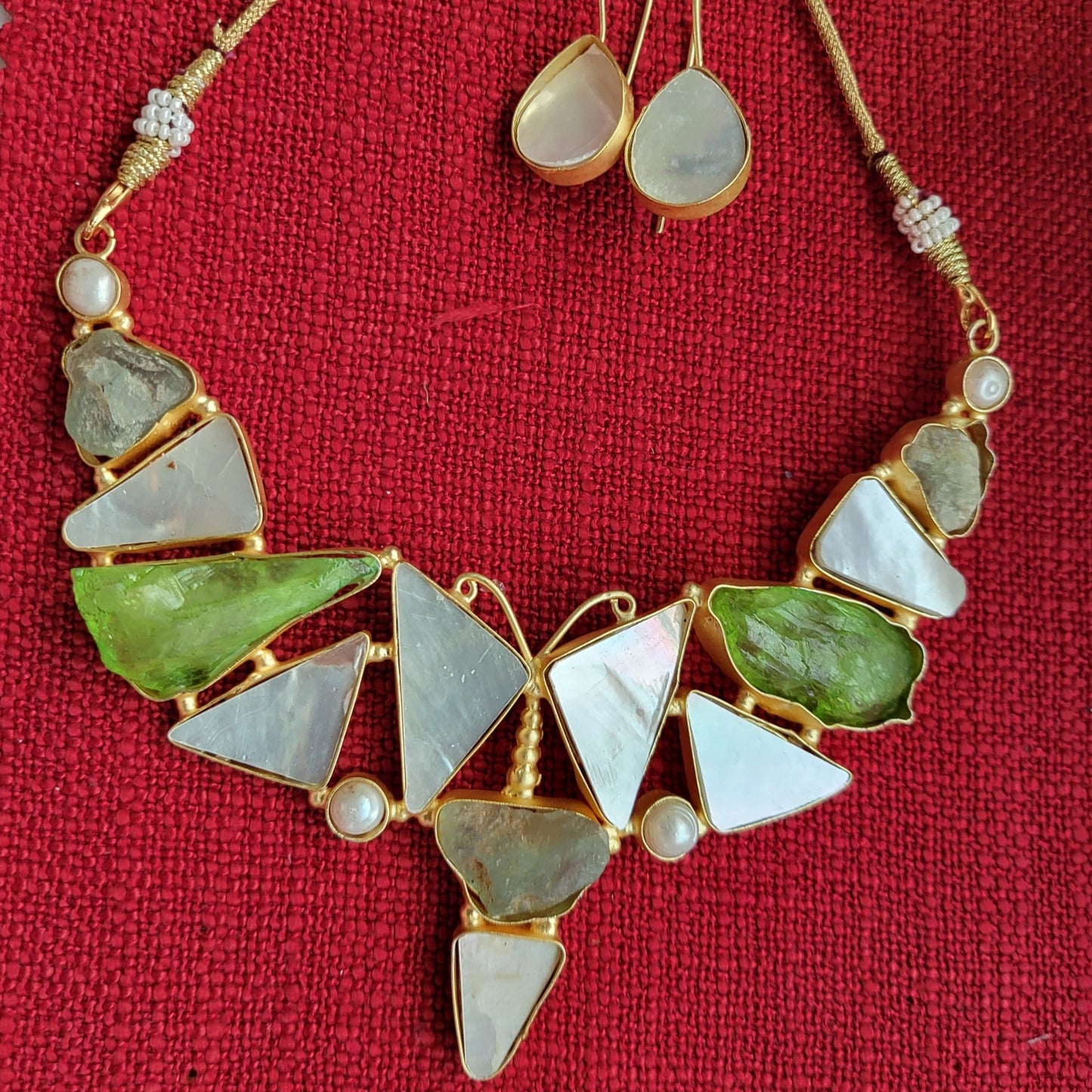 Moonstone, green uncut stones and a butterfly
