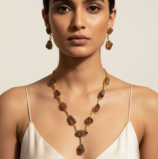 Woman wearing a necklace and earrings on a beige background